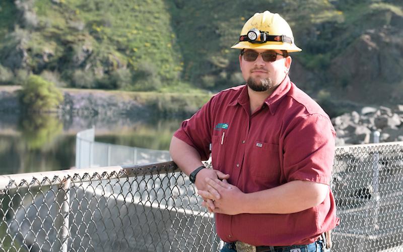 Generation apprentice standing next to a fence